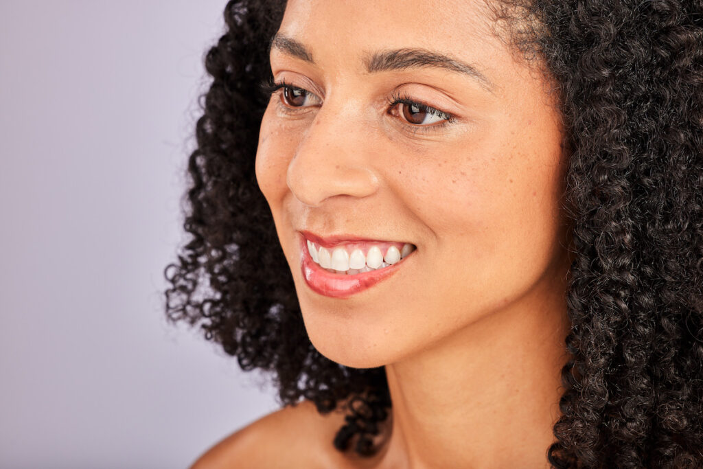 A woman is smiling and showing off the results of her buccal fat removal in Oklahoma City.