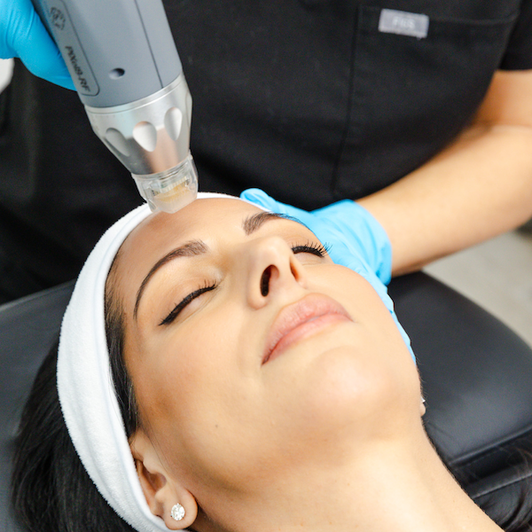 A patient is laying down during their RF microneedling treatment for skin rejuvenation near Edmond, OK.